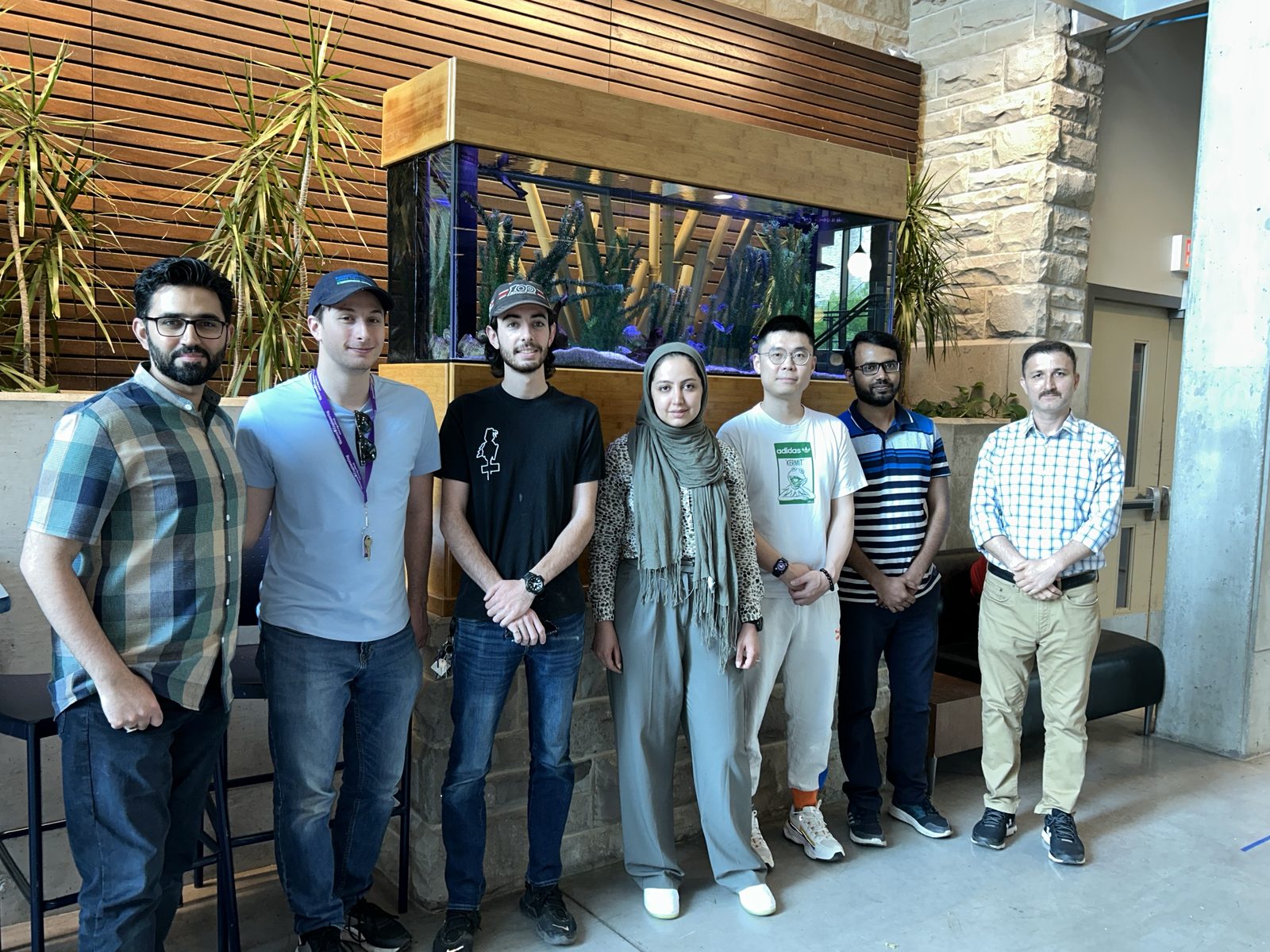 Lab members standing together in a building lobby